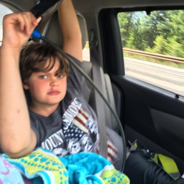 This morning (Monday) we set out for Glacier Park. Sara sleeps under a towel and Edan supplies her with water from his hydration pack (a must for any cross country road trip).