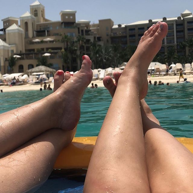 Sara and Kris’ feet in a water hammock in the ocean